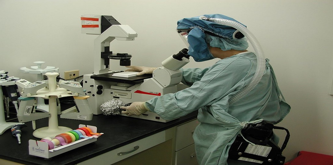 lab member using microscope